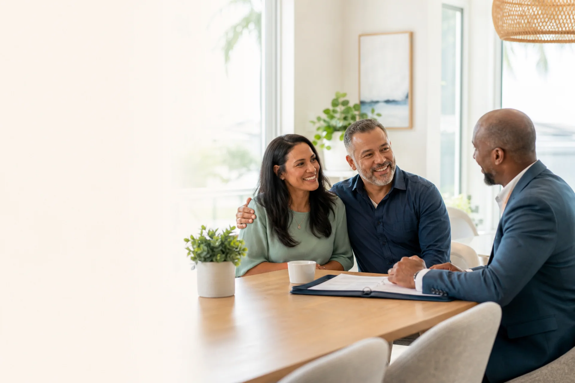 Couple sharing a relaxed smile with their insurance advisor