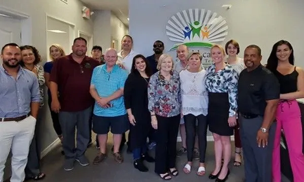 Healthcare Solutions Team Brandon staff posing together in their office